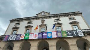 Los pendones de las cofradías y hermandades de Cáceres lucen en la fachada de la Casa Consistorial